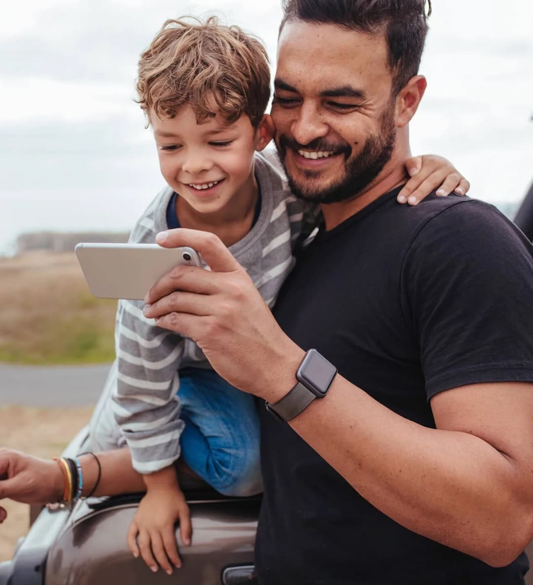 Father with son looking at phone.